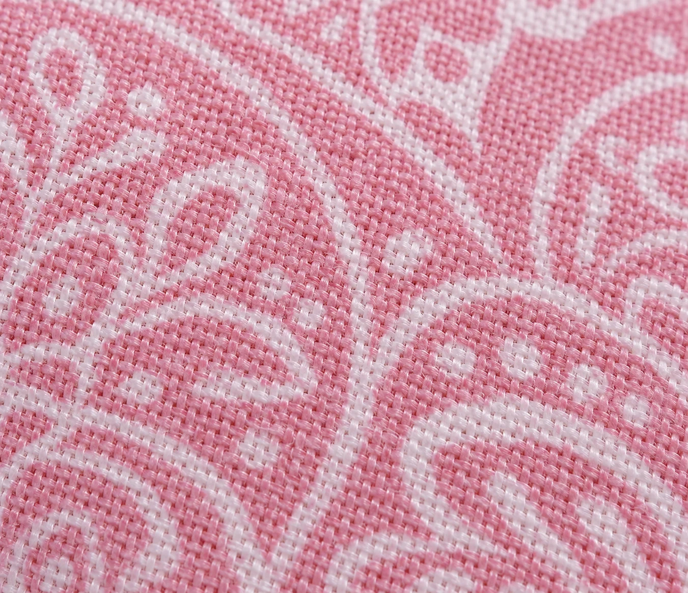 Blush pink bed linen with an ornate white paisley pattern