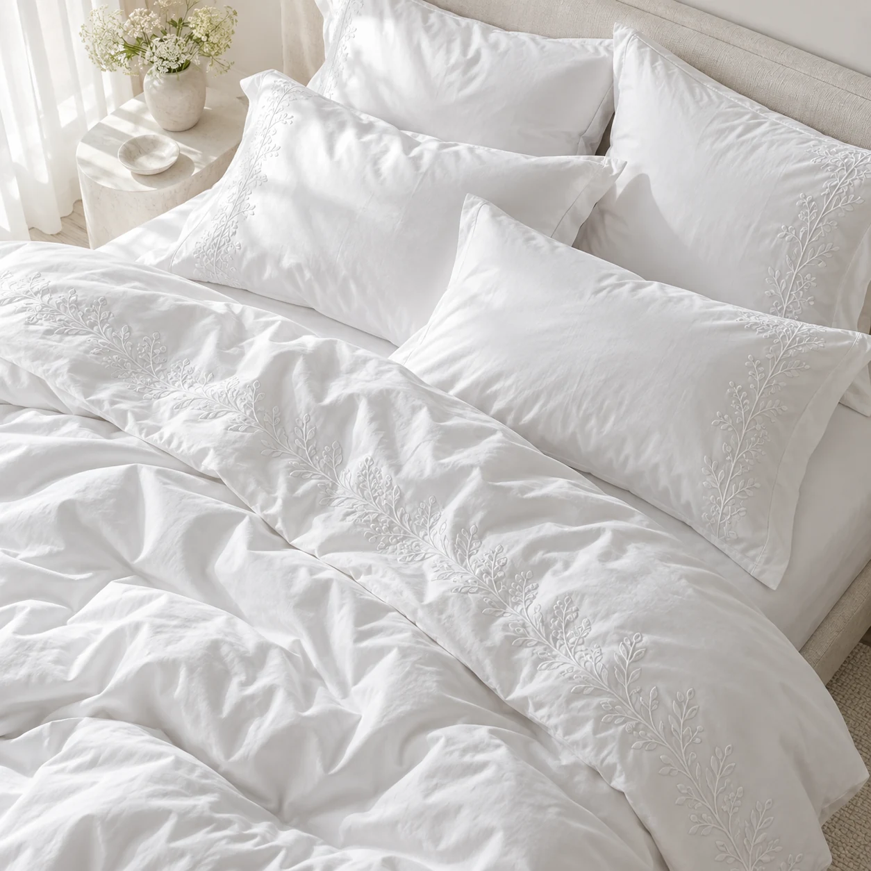 Close-up of white embroidered bed linens