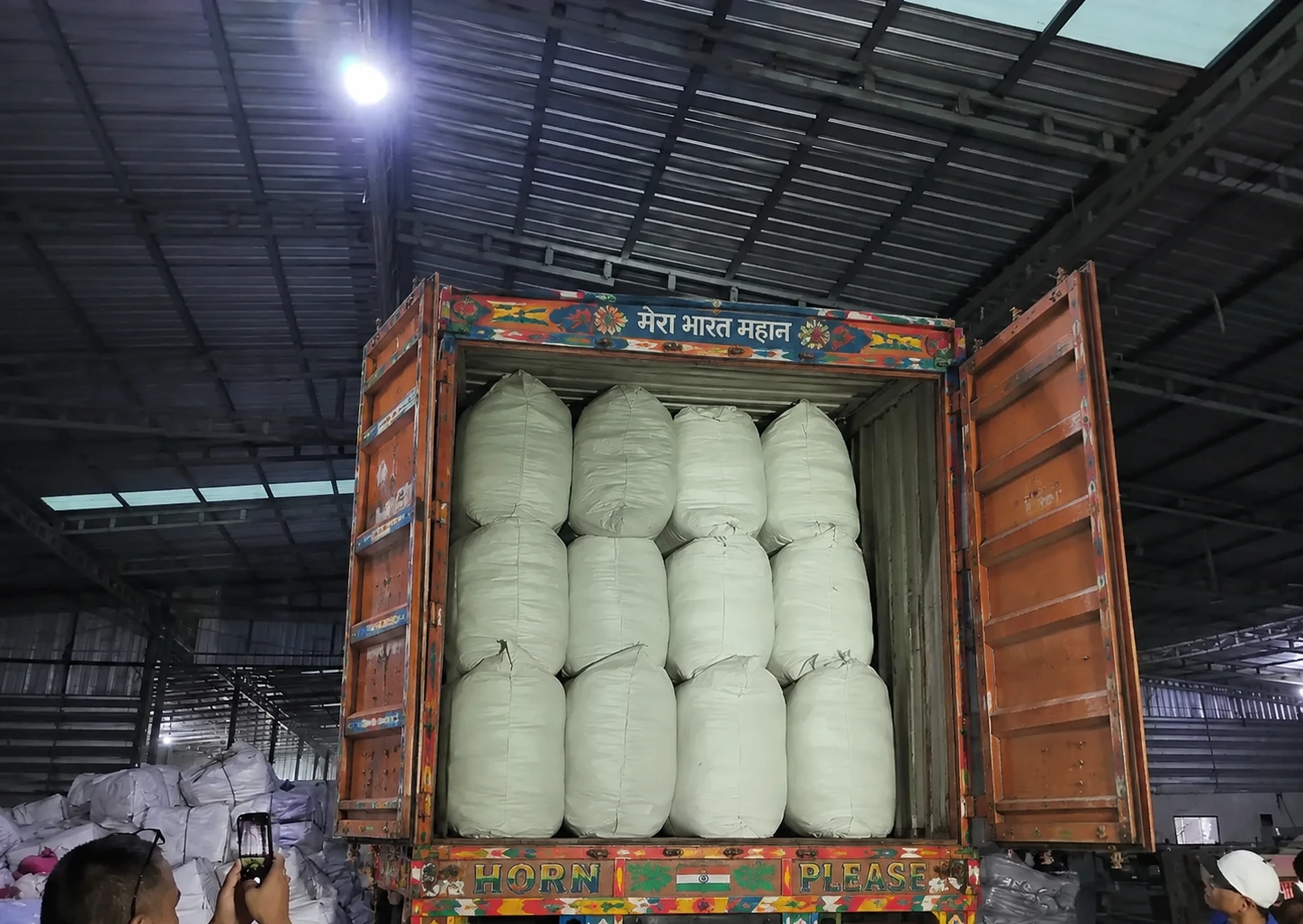Textile bundles being loaded into a delivery truck